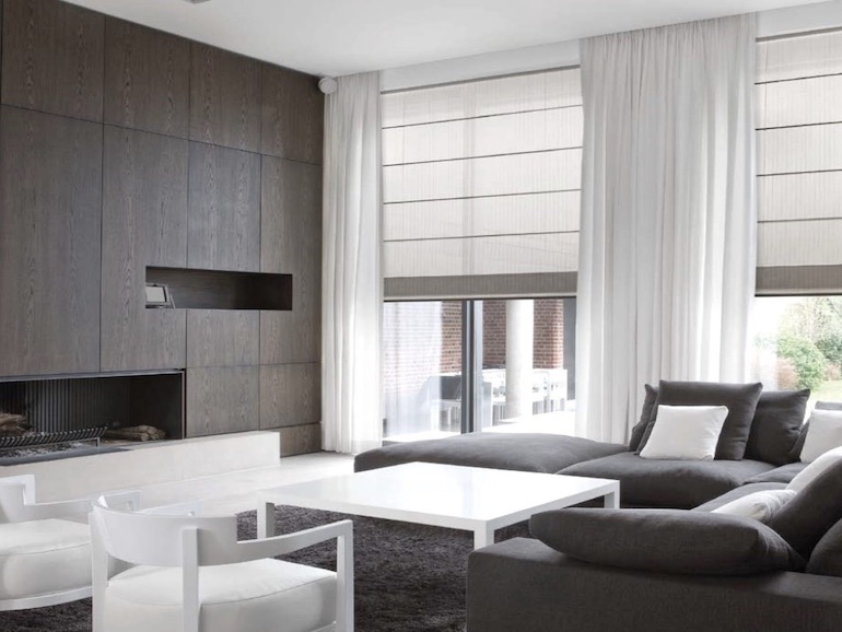 Living room with sheer curtains and roman blinds